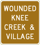 Vulcan Signs - Traffic Generator Signs - Wounded Knee Creek And Village Sign